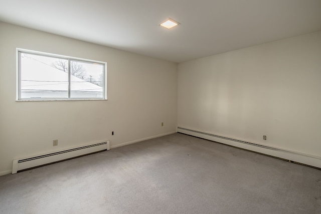 carpeted spare room featuring a baseboard radiator