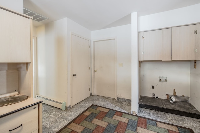 kitchen with light brown cabinets and baseboard heating