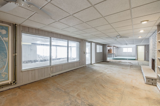 interior space with baseboard heating, a paneled ceiling, and ceiling fan