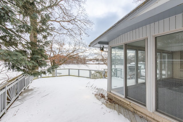 yard layered in snow with a wooden deck