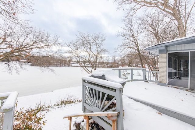 snowy yard featuring a wooden deck