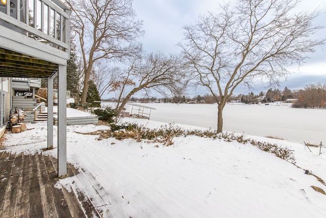 snowy yard featuring a deck