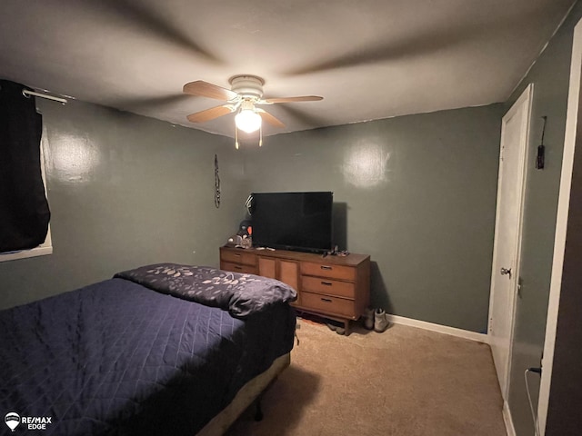 bedroom featuring ceiling fan and light carpet