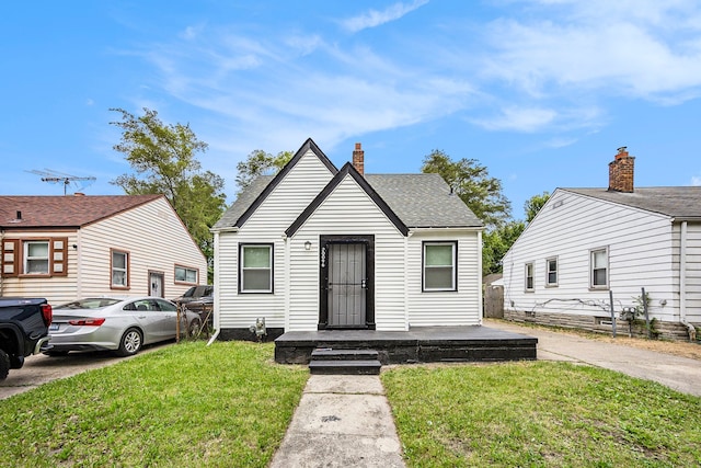 bungalow-style house featuring a front yard