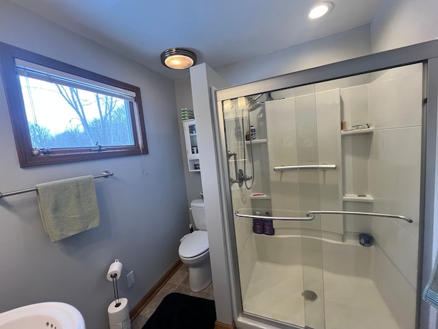 bathroom with toilet and walk in shower