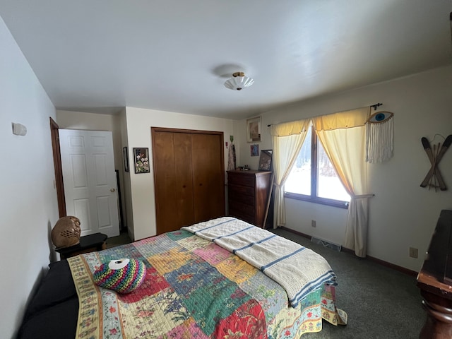 bedroom with dark carpet and a closet