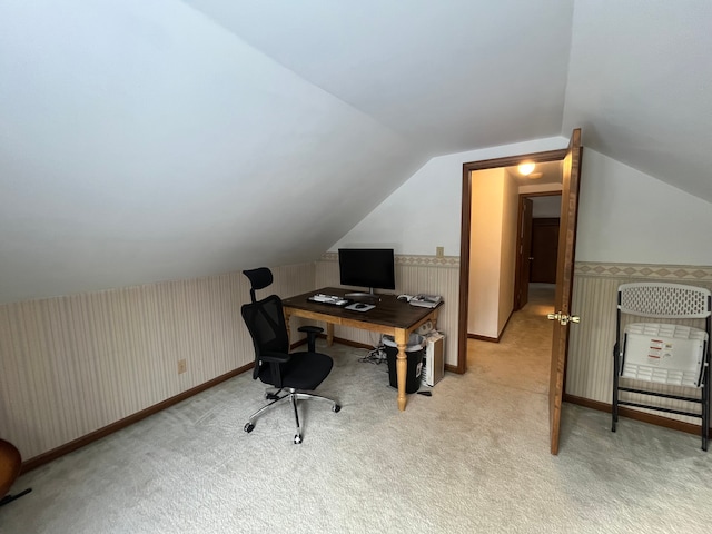 carpeted office featuring lofted ceiling