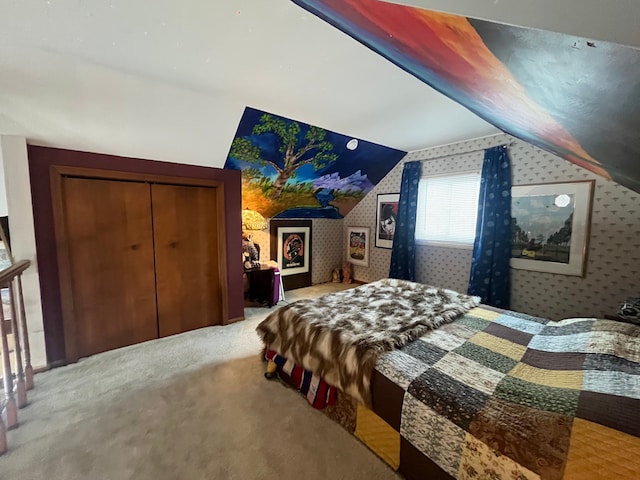 carpeted bedroom with lofted ceiling and a closet