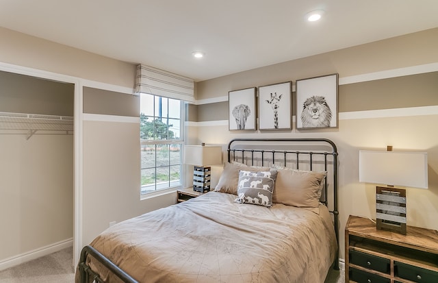 bedroom with carpet flooring, recessed lighting, baseboards, and a closet