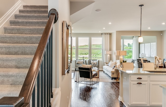 stairs featuring baseboards, wood finished floors, and recessed lighting