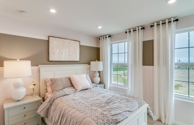 bedroom with recessed lighting and multiple windows