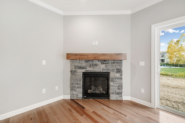 room details featuring a fireplace, hardwood / wood-style flooring, and ornamental molding