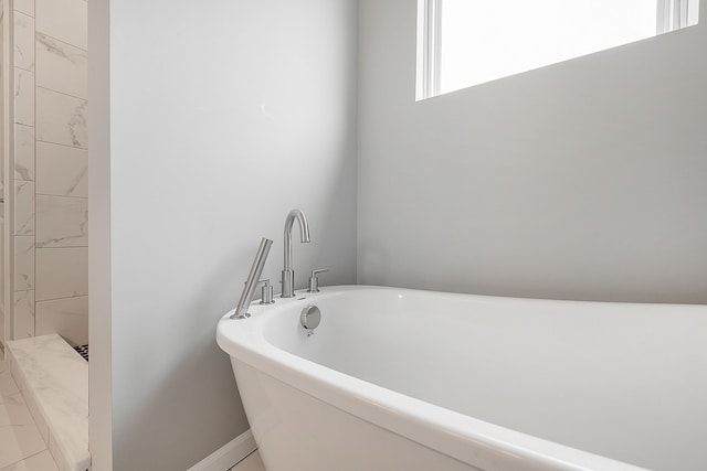 bathroom featuring a tub to relax in