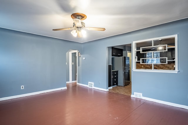 unfurnished room with hardwood / wood-style floors and ceiling fan