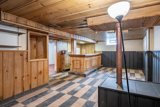 interior space featuring wooden ceiling and wooden walls