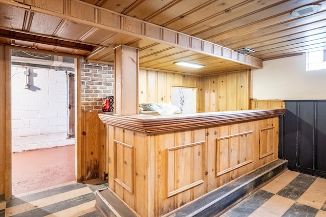 bar with light brown cabinetry and wood ceiling