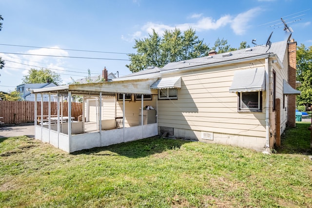 back of property featuring a lawn