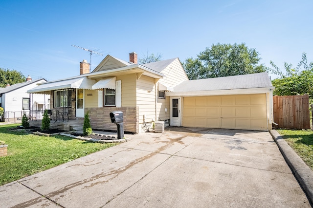 view of front of home featuring a garage and a front yard