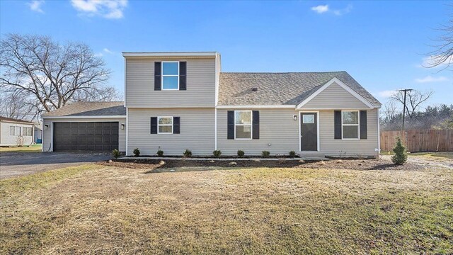 view of front of house featuring a garage and a front lawn