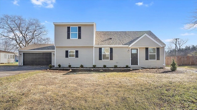 view of front of home with a garage and a front yard