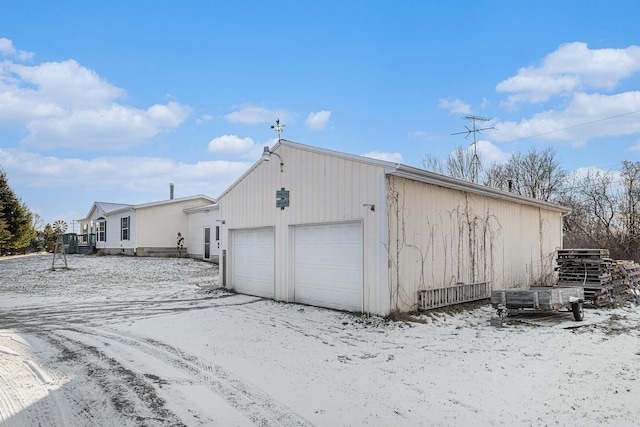 exterior space with a garage and an outdoor structure