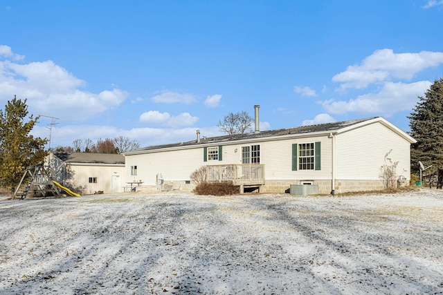 manufactured / mobile home with a wooden deck and central AC