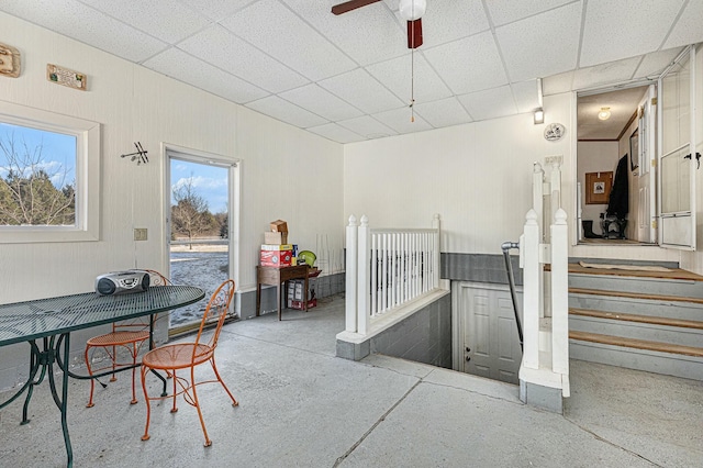 interior space with a drop ceiling and ceiling fan