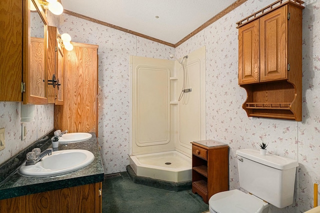 bathroom featuring vanity, toilet, ornamental molding, a textured ceiling, and walk in shower