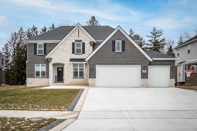 view of front of home with a garage and a front lawn