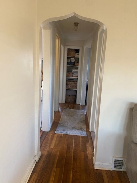 hallway with dark hardwood / wood-style floors