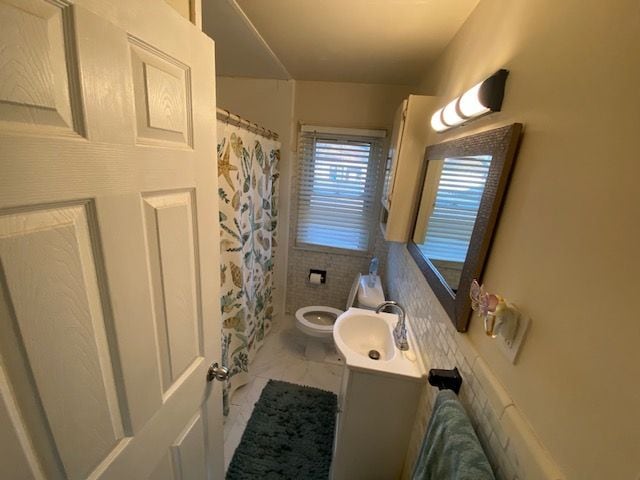 bathroom featuring tile patterned floors, vanity, and toilet