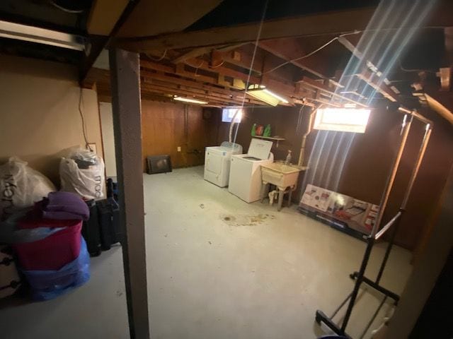 basement featuring washer and dryer and sink