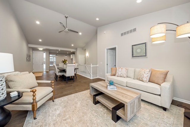 living room with ceiling fan, light wood-type flooring, and lofted ceiling