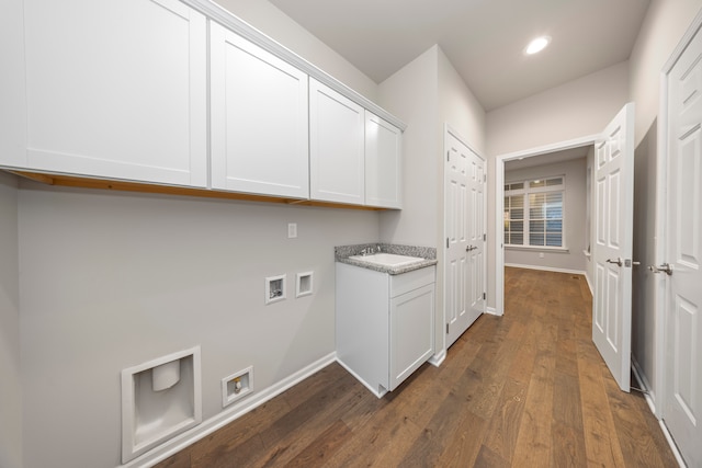 washroom with washer hookup, dark hardwood / wood-style floors, and cabinets