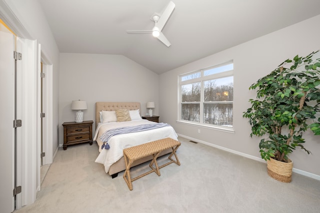 bedroom featuring ceiling fan, light colored carpet, and lofted ceiling