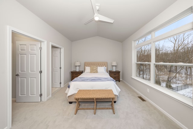 carpeted bedroom with vaulted ceiling and ceiling fan