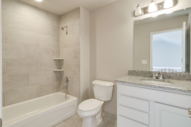 full bathroom with vanity, tile patterned floors, tiled shower / bath combo, and toilet