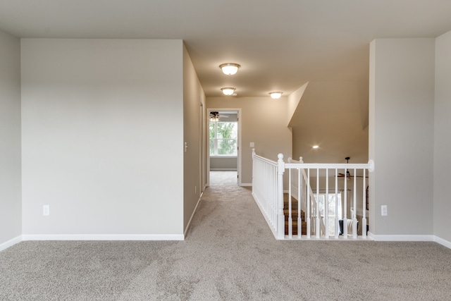 hallway with light colored carpet