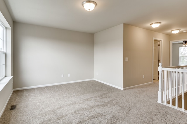 carpeted empty room with ceiling fan