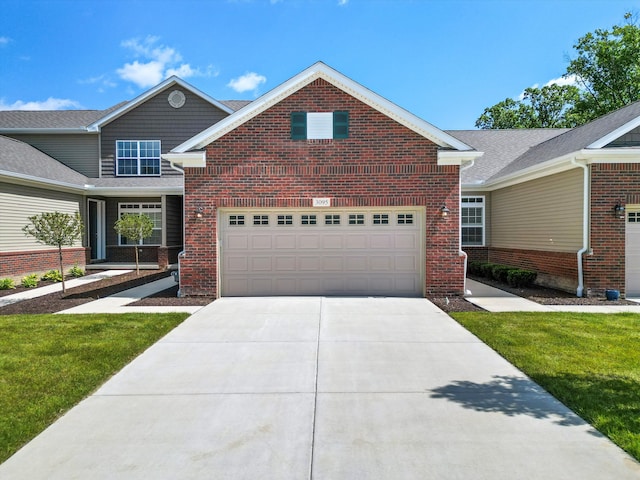 view of front of property featuring a garage and a front lawn