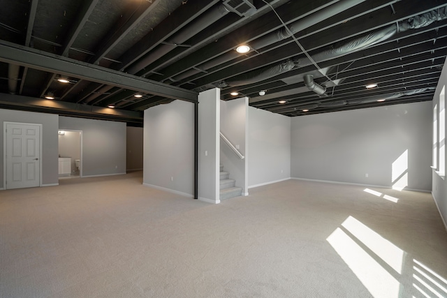 basement featuring light colored carpet