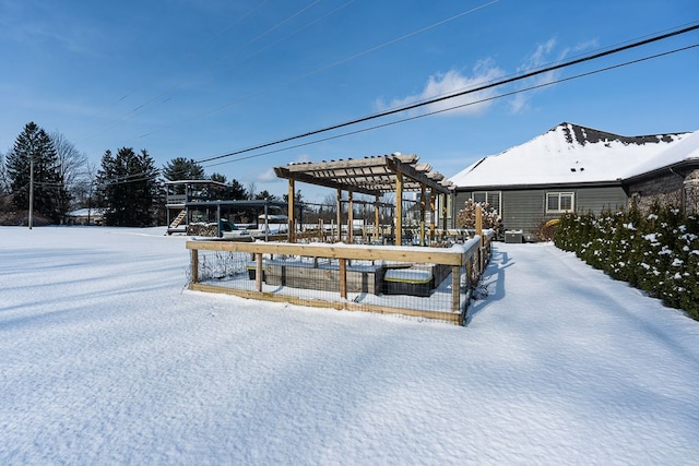 yard layered in snow with a pergola