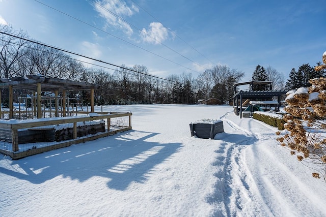 yard layered in snow featuring a pergola