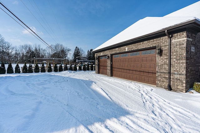 snowy yard with a garage