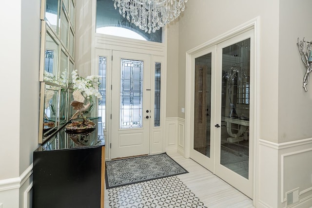 foyer with an inviting chandelier and french doors