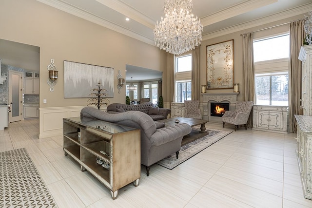 living room featuring a notable chandelier, crown molding, and light tile patterned floors