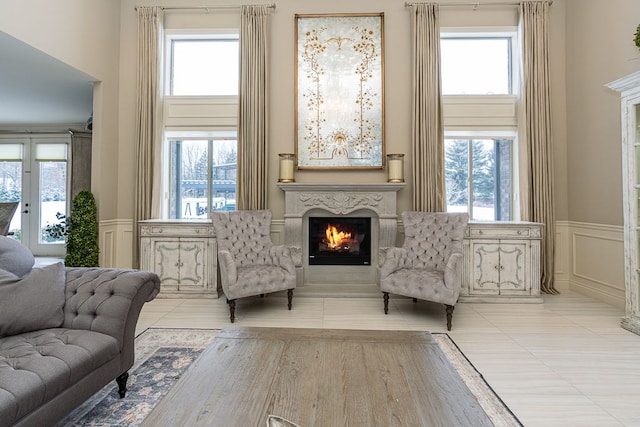 sitting room featuring light tile patterned flooring, a fireplace, and a wealth of natural light