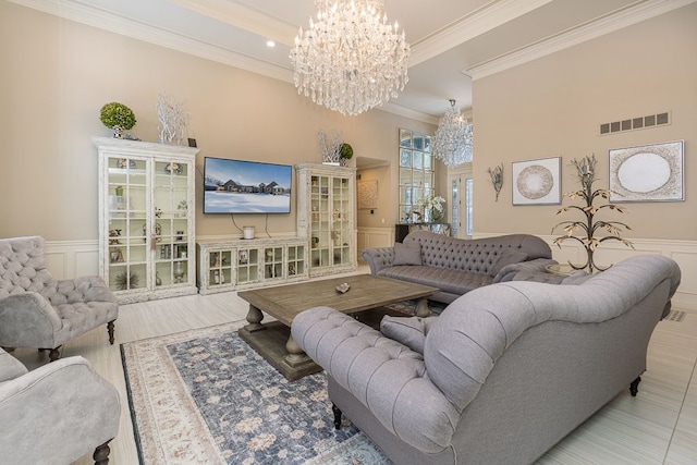 living room featuring a chandelier and ornamental molding