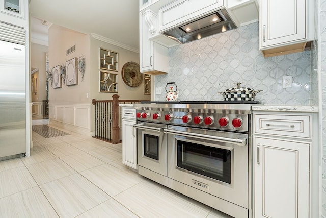 kitchen with white cabinets, custom exhaust hood, crown molding, and premium appliances