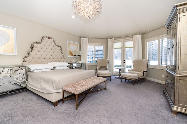 bedroom with french doors, carpet flooring, and an inviting chandelier